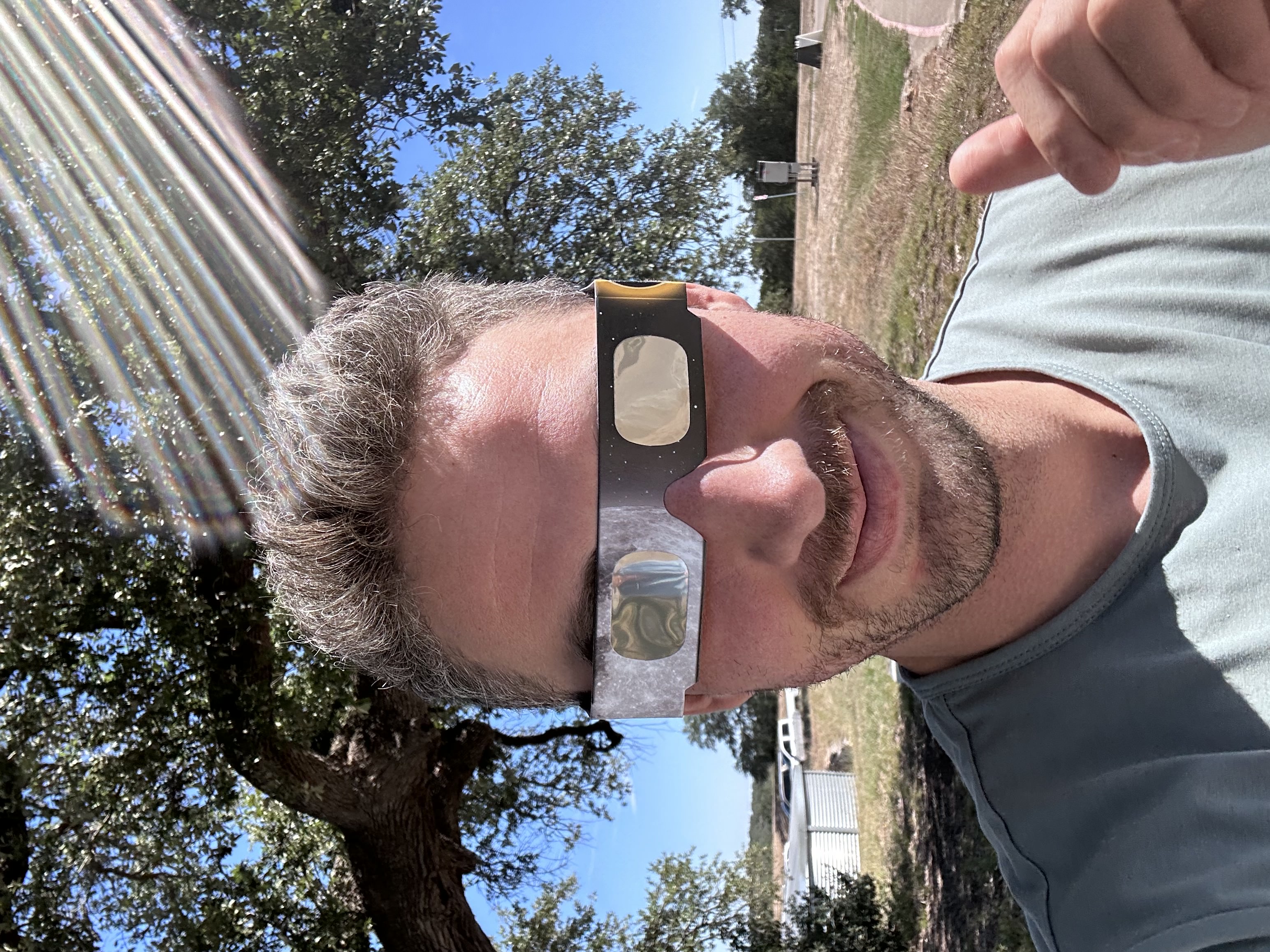 Steven Turner smiling with eclipse glasses